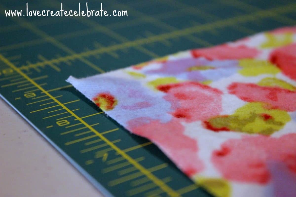 Flowered fabric laid out on cutting mat 