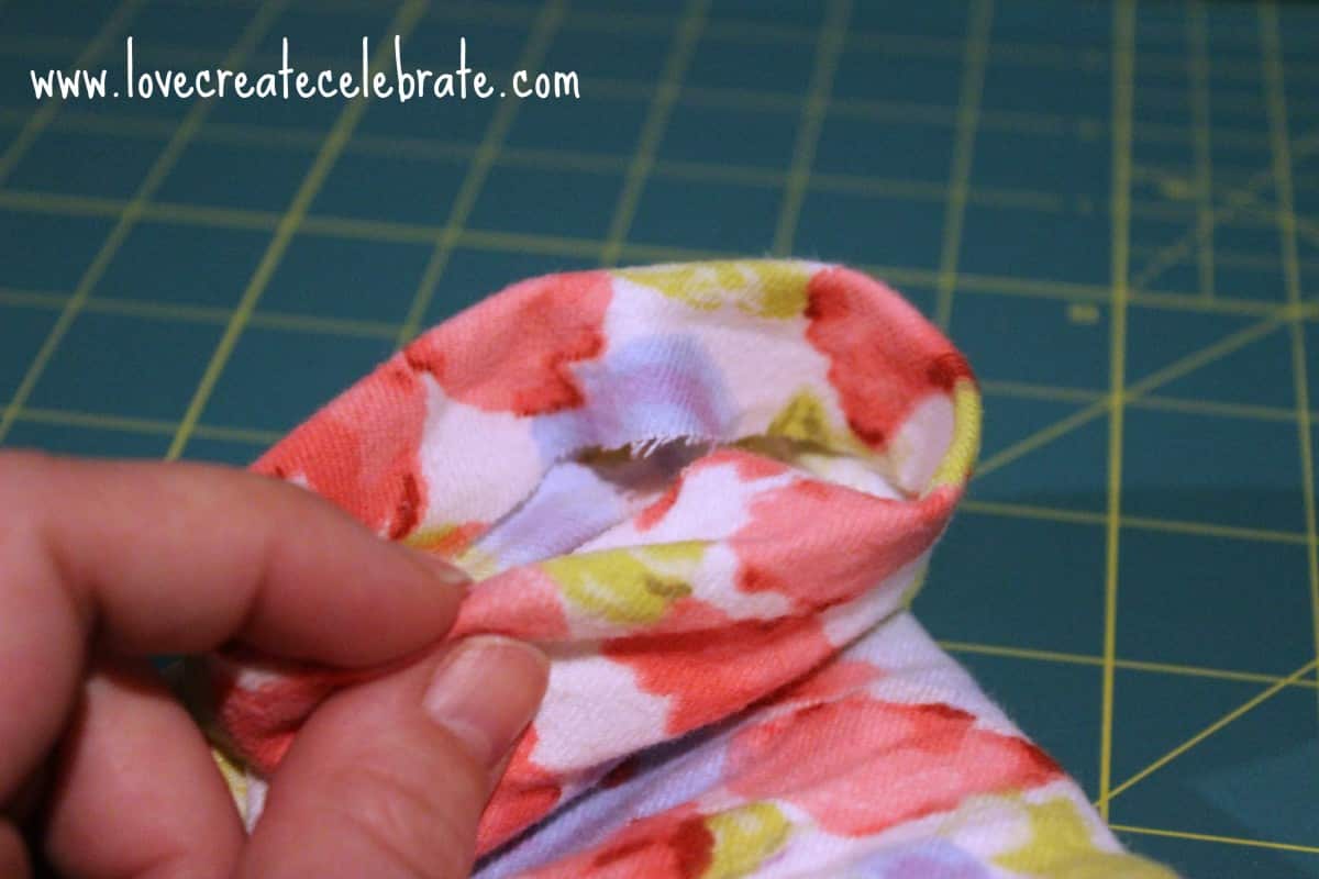 Folding edge down on baby infinity scarf to create a seam