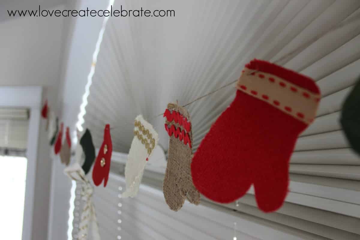 Closeup of burlap Christmas decoration mitten garland. 
