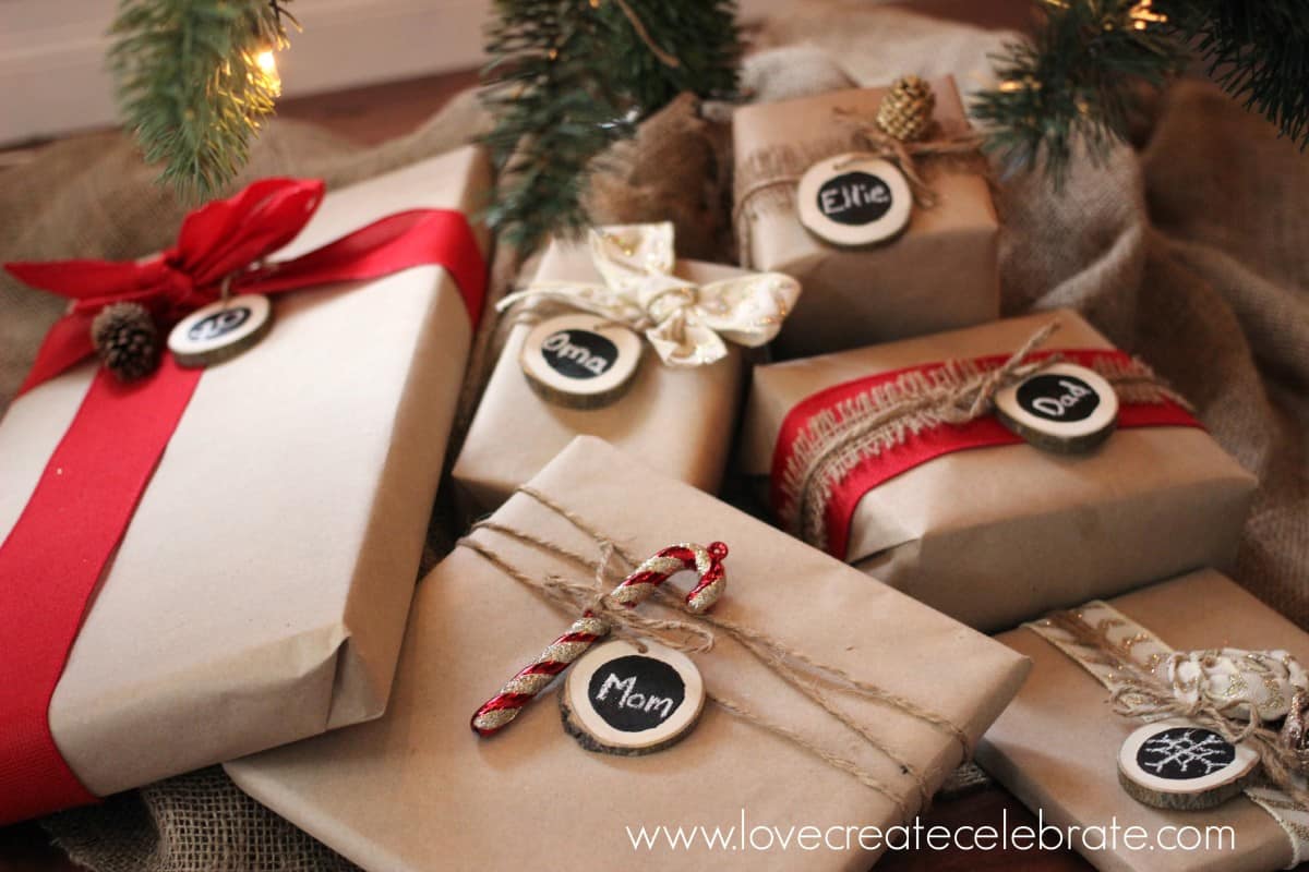 closeup of brown paper wrapped presents underneath Christmas tree