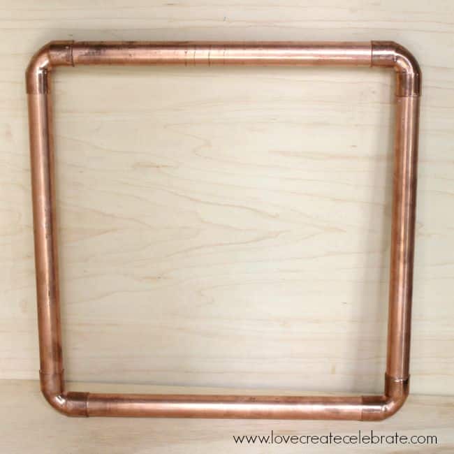 Creating the frame for the DIY copper pipe fall wreath. 