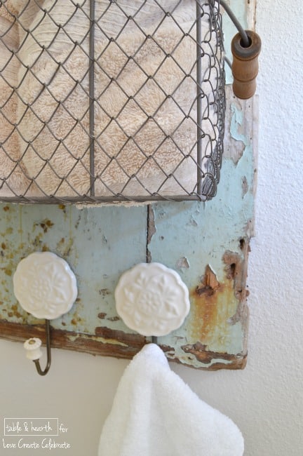 Pretty shabbiness! This blogger took an old piece of wood washed up on the beach and made this adorable rustic towel holder with it!