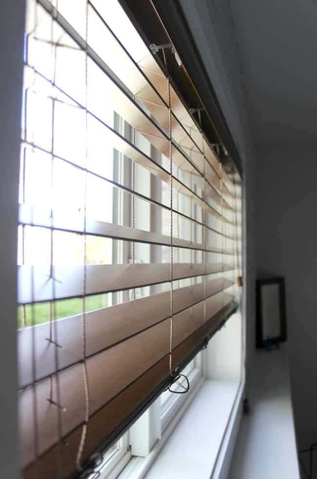 Love the mix of modern and industrial decor in this bedroom design! Beautiful faux wood blinds!