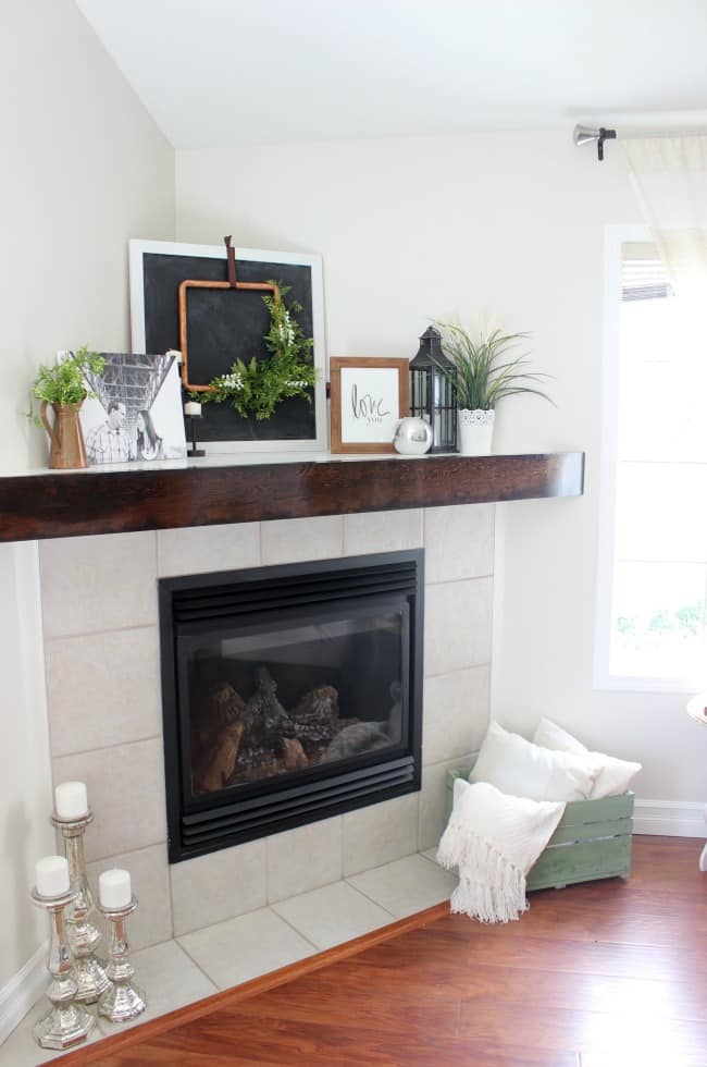 This rustic wooden mantel was an easy DIY project that gave our fireplace a whole new look