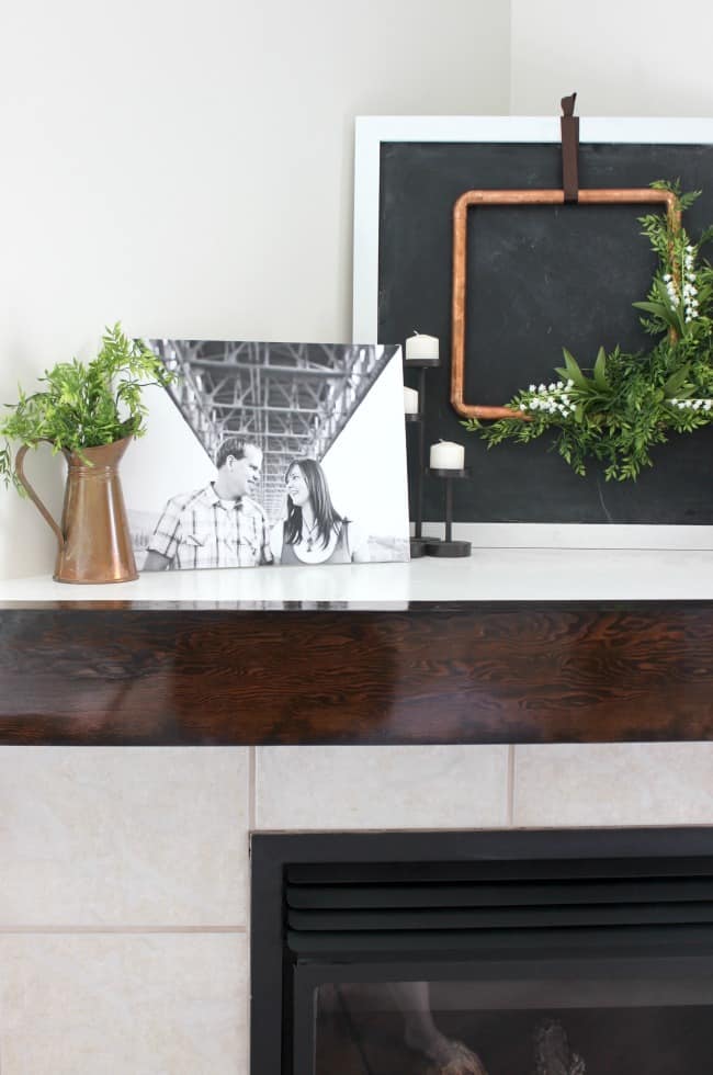This DIY wooden mantel adds a fresh style to our living room fireplace, and it was a super easy project!
