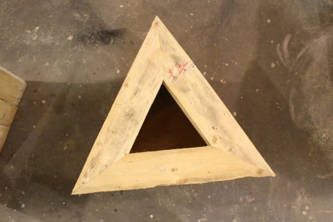 Nail the top triangle into place on the triangle pallet planter