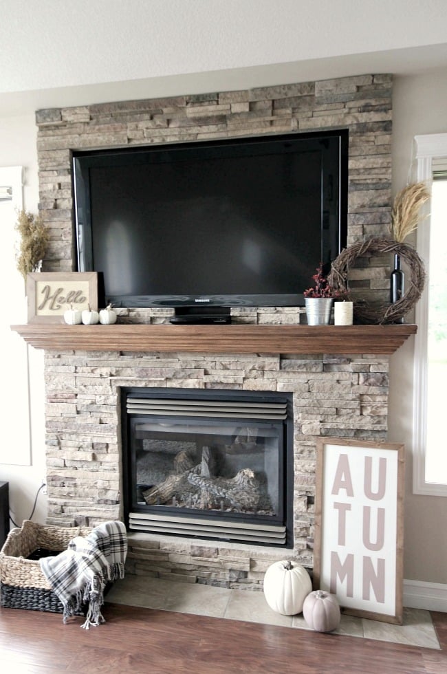 Using the fire place as a central point for some fall decor is a great idea