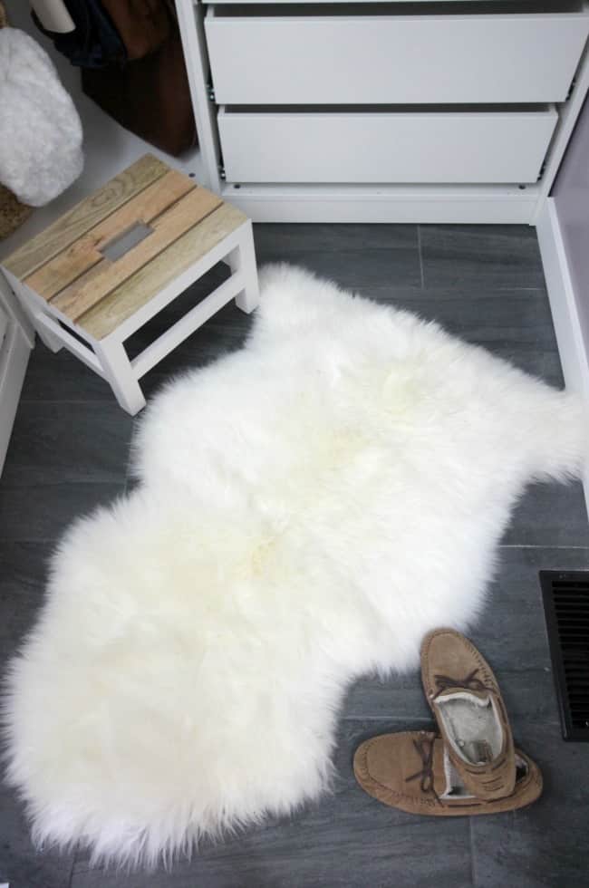 This charcoal tile floor and sheepskin rug look amazing in our new dream closet.