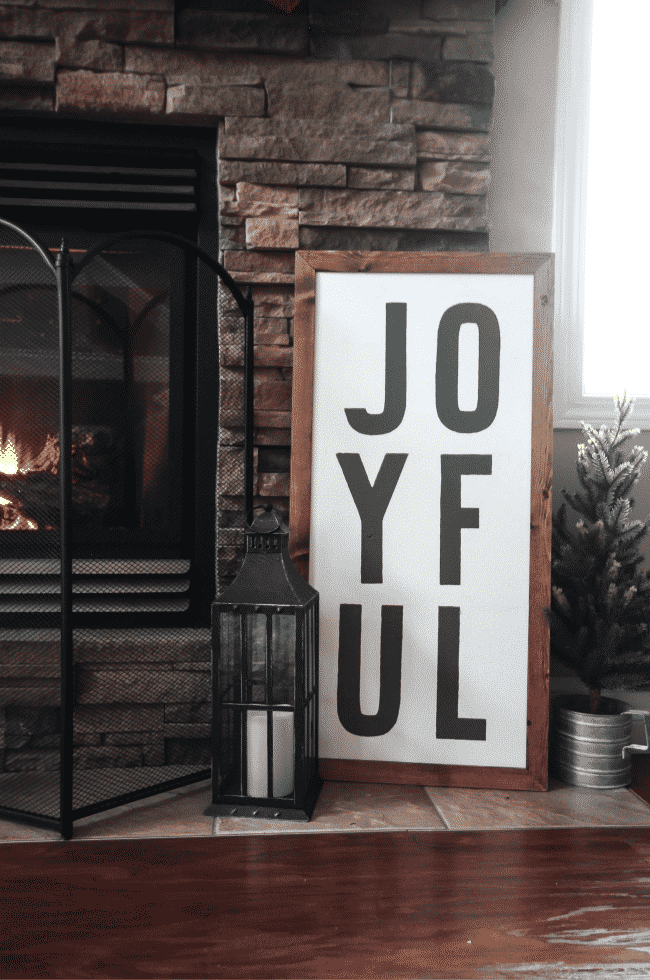 A beautiful rustic fireplace mantel for Christmas! Love the floor to ceiling brick and all of the natural decorations!