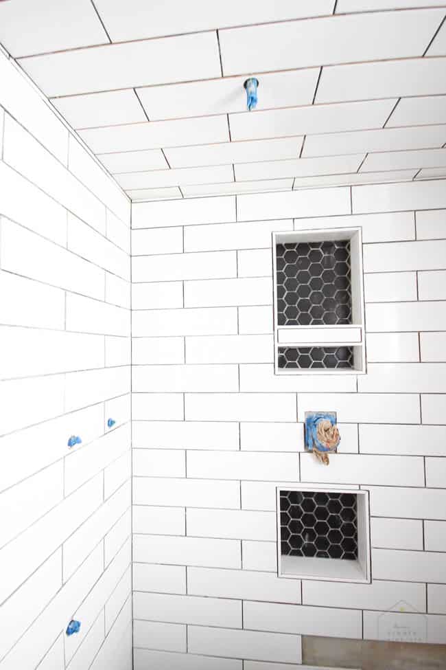 Update on our modern bathroom renovation! LOVE these beautiful shower tiles!