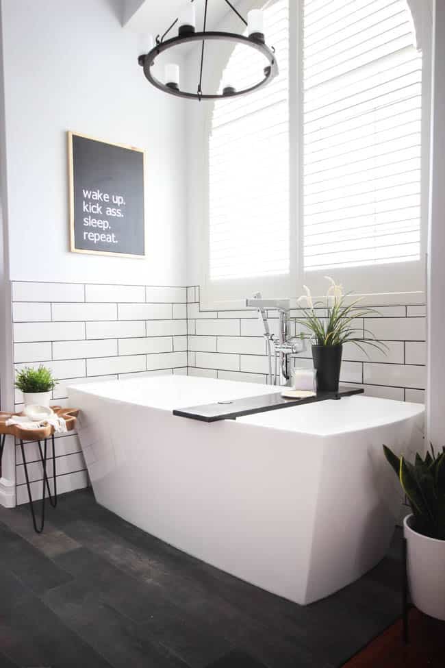 A beautiful modern bathroom renovation with chrome and matte black faucets, sleek modern fixtures and natural wood accents. Beautiful transformation!