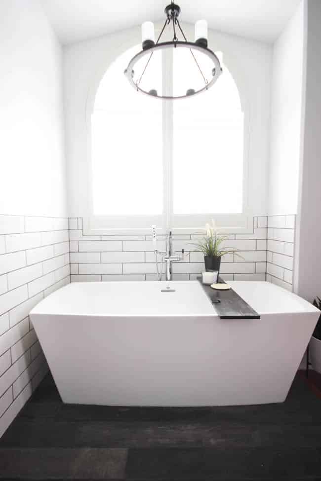 A beautiful modern bathroom renovation with chrome and matte black faucets, sleek modern fixtures and natural wood accents. Beautiful transformation! 