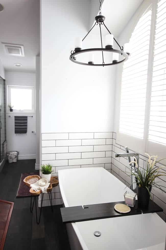 A beautiful modern bathroom renovation with chrome and matte black faucets, sleek modern fixtures and natural wood accents. Beautiful transformation! 