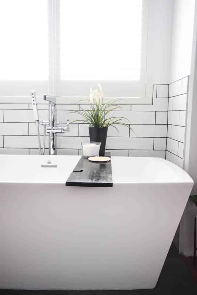 A beautiful modern bathroom renovation with chrome and matte black faucets, sleek modern fixtures and natural wood accents. Beautiful transformation! 