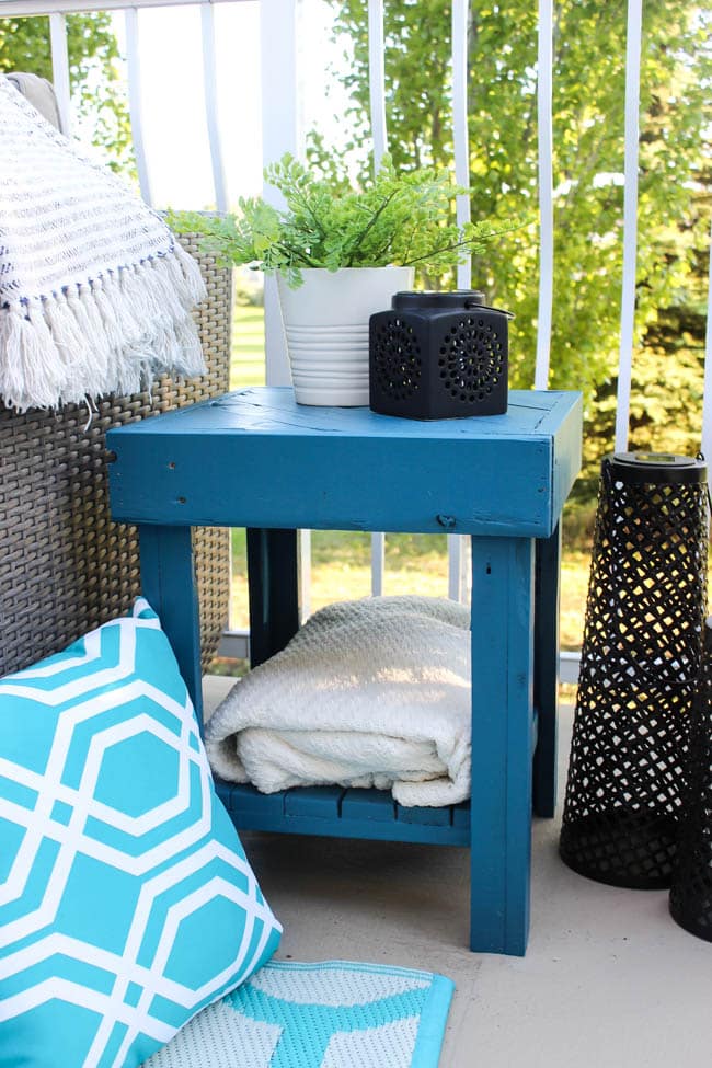 A stunning backyard makeover inspired completed with Behr paints. Love the bright painted blue doors, and the grey outdoor sectional. Beautiful DIY pallet side tables, and black and white accessories complete the space. Summer is here! 