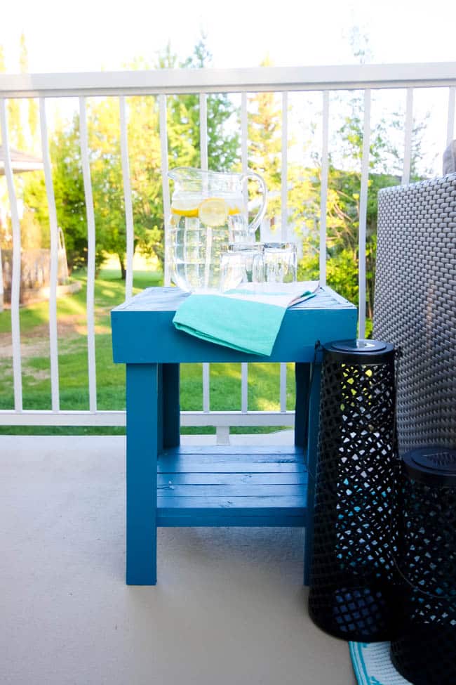 A stunning backyard makeover inspired completed with Behr paints. Love the bright painted blue doors, and the grey outdoor sectional. Beautiful DIY pallet side tables, and black and white accessories complete the space. Summer is here! 