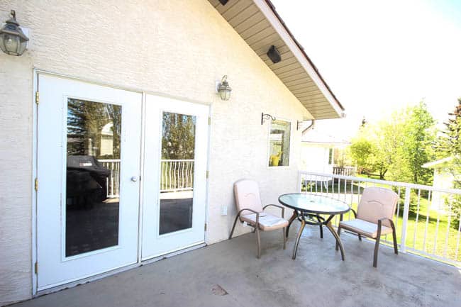 A stunning backyard makeover inspired completed with Behr paints. Love the bright painted blue doors, and the grey outdoor sectional. Beautiful DIY pallet side tables, and black and white accessories complete the space. Summer is here! 