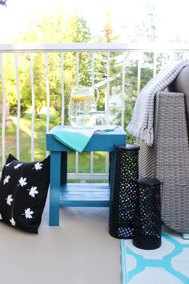 A stunning backyard makeover inspired completed with Behr paints. Love the bright painted blue doors, and the grey outdoor sectional. Beautiful DIY pallet side tables, and black and white accessories complete the space. Summer is here! 