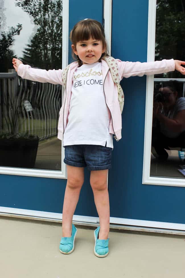 Little girl wearing t-shirt with text "Preschool Here I Come"