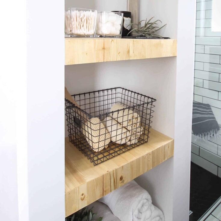 Make your own modern Built-In Shelving with this simple DIY tutorial. Love the natural wood used in this beautiful bathroom renovation! Great tutorial for DIY shelving in the bedroom, living room, or any room!