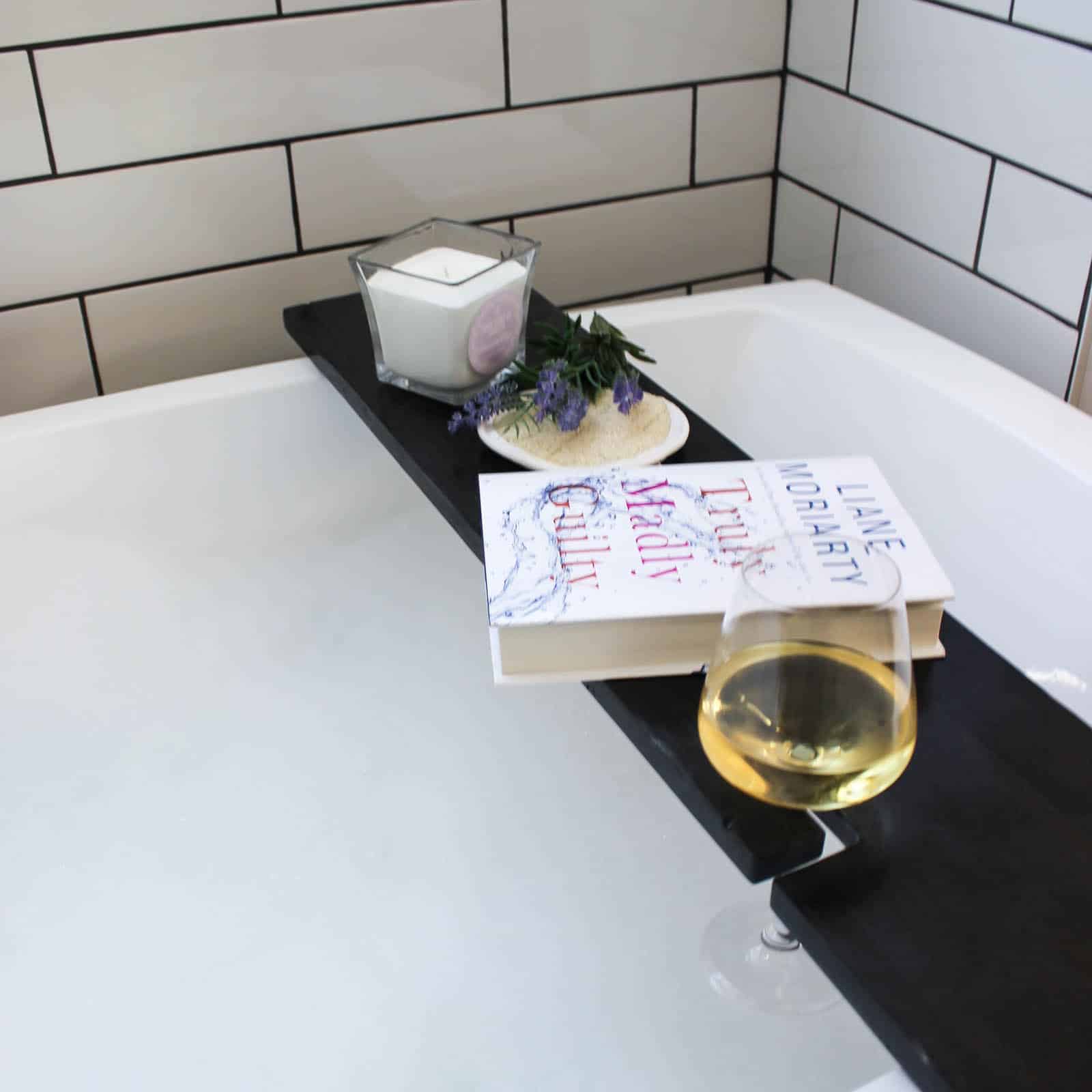 Build your own DIY Bath Table with this simple tutorial! Bath trays are the perfect bathroom accessories to add character and style! Love that this bathtub tray has a wine glass holder too!