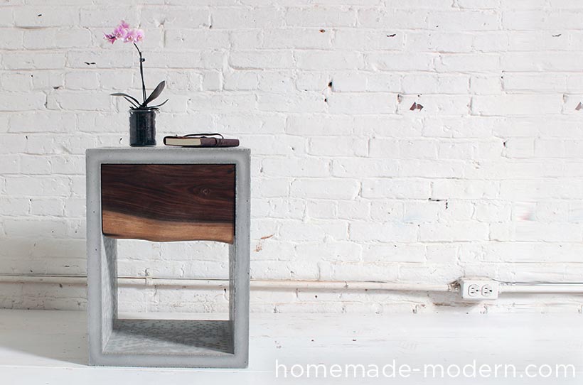 A concrete nightstand is simple and functional.