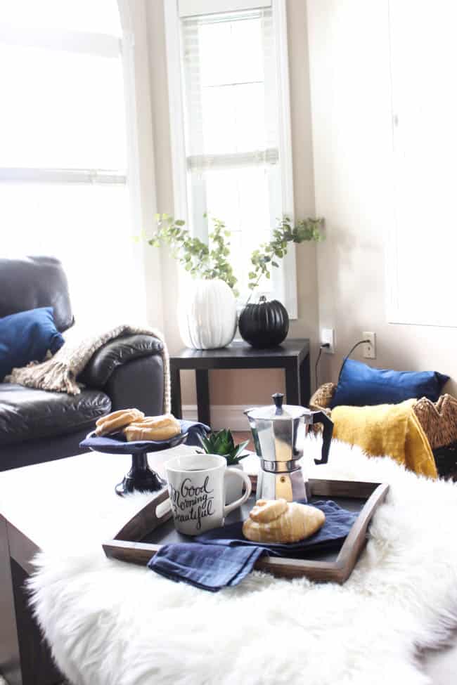 A snack tray on the coffee table matches the decor and serves practically