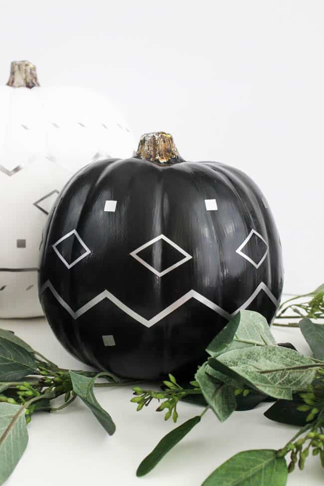 Make your own modern fall decor! Use your Cricut Machine and adhesive foil to create these beautiful patterned pumpkins! LOVE the navy, black and white pumpkins for a non-traditional fall!