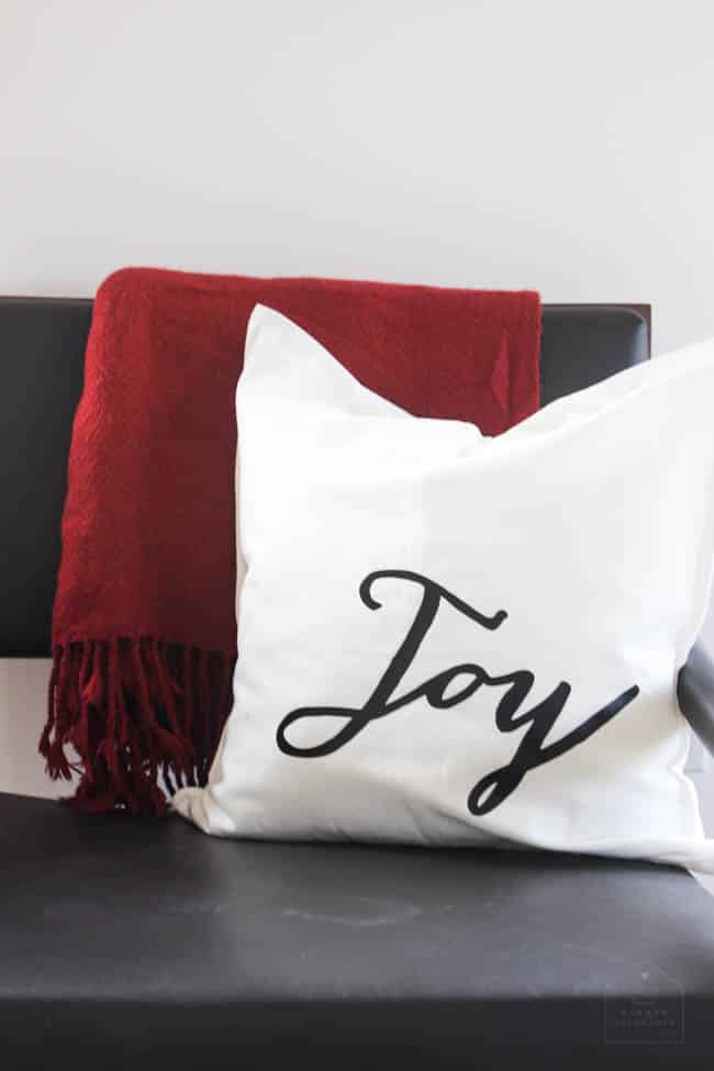 The easiest ever Christmas Pillows to make! These festive DIY holiday pillows will have everyone wondering where you bought them! Make them in less than 30 minutes and enjoy these modern pillows for the entire season. Download the "joy" and deer images free!