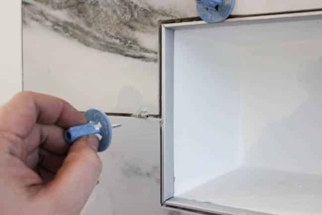 Easily remove the leveling spindles after the tiles dry, before grouting 