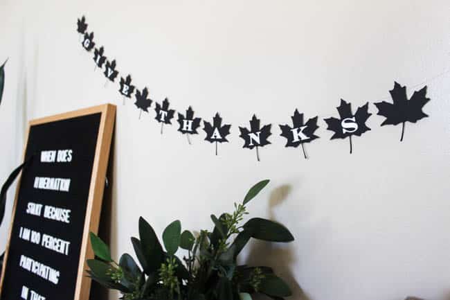 A beautiful modern fall decor idea. Make this simple black and white DIY leaf banner to celebrate Thanksgiving Day!