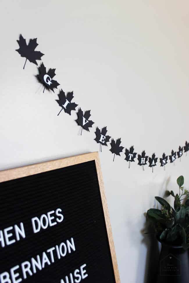 A beautiful modern fall decor idea. Make this simple black and white DIY leaf banner to celebrate Thanksgiving Day!