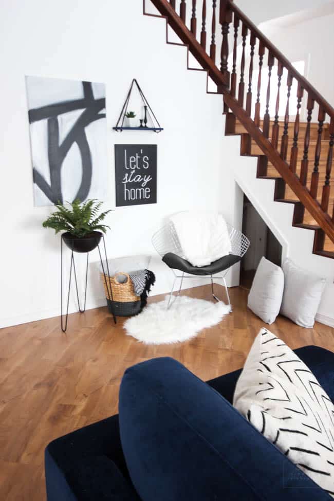 This gorgeous Modern Living Room reveal is finally here! This space came a long way from an outdated, empty space in this beautiful barn home. Love all of the contemporary DIY and decor ideas in this beautiful living space! The tiled fireplace and blue couch are stunning!