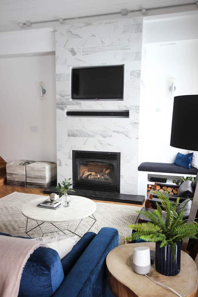 This gorgeous Modern Living Room reveal is finally here! This space came a long way from an outdated, empty space in this beautiful barn home. Love all of the contemporary DIY and decor ideas in this beautiful living space! The tiled fireplace and blue couch are stunning!