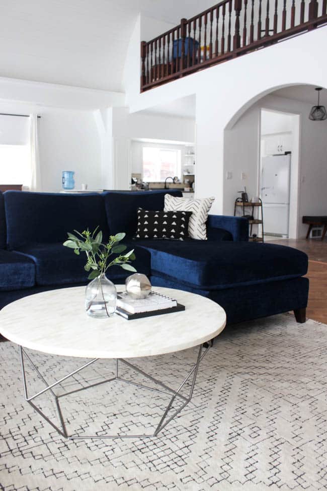 This gorgeous Modern Living Room reveal is finally here! This space came a long way from an outdated, empty space in this beautiful barn home. Love all of the contemporary DIY and decor ideas in this beautiful living space! The tiled fireplace and blue couch are stunning!