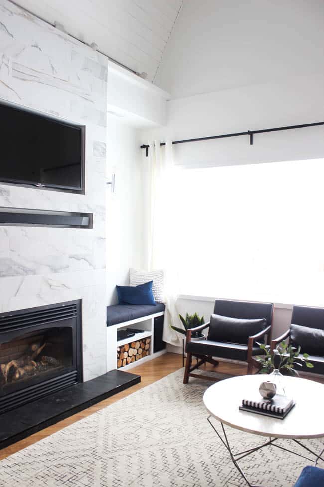 This gorgeous Modern Living Room reveal is finally here! This space came a long way from an outdated, empty space in this beautiful barn home. Love all of the contemporary DIY and decor ideas in this beautiful living space! The tiled fireplace and blue couch are stunning!