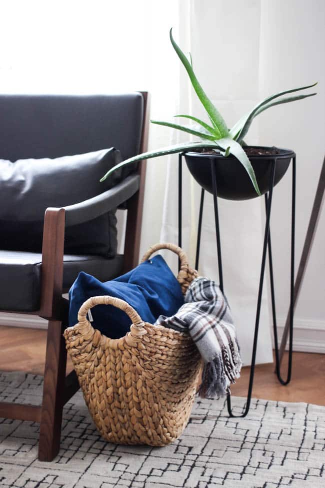 This gorgeous Modern Living Room reveal is finally here! This space came a long way from an outdated, empty space in this beautiful barn home. Love all of the contemporary DIY and decor ideas in this beautiful living space! The tiled fireplace and blue couch are stunning!