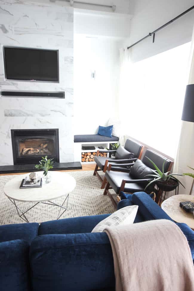 This gorgeous Modern Living Room reveal is finally here! This space came a long way from an outdated, empty space in this beautiful barn home. Love all of the contemporary DIY and decor ideas in this beautiful living space! The tiled fireplace and blue couch are stunning!