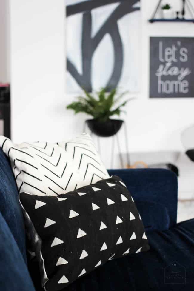 This gorgeous Modern Living Room reveal is finally here! This space came a long way from an outdated, empty space in this beautiful barn home. Love all of the contemporary DIY and decor ideas in this beautiful living space! The tiled fireplace and blue couch are stunning!