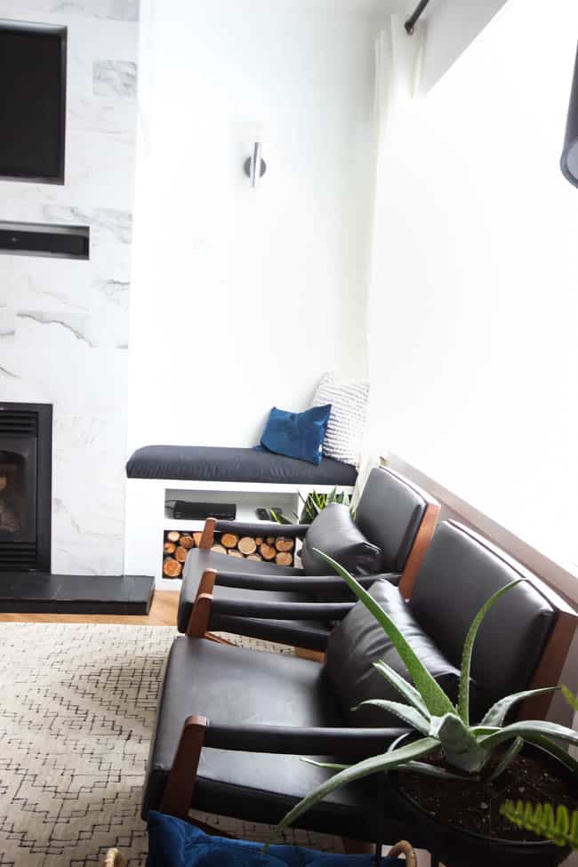 This gorgeous Modern Living Room reveal is finally here! This space came a long way from an outdated, empty space in this beautiful barn home. Love all of the contemporary DIY and decor ideas in this beautiful living space! The tiled fireplace and blue couch are stunning!