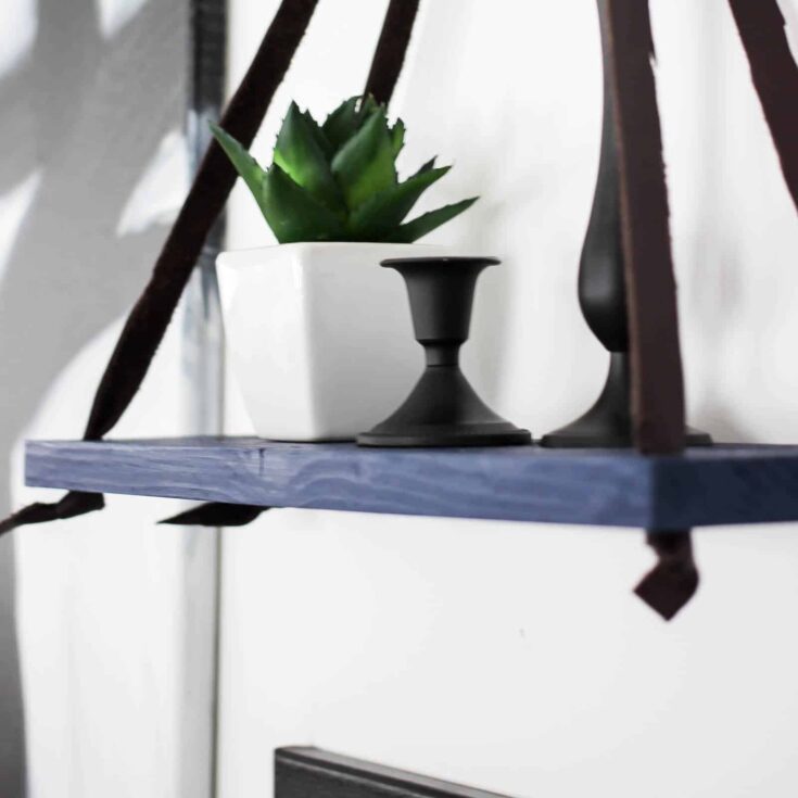 Love this simple modern shelf idea! This simple DIY hanging shelf makes the perfect wall art. If you have some scrap wood and leather you can make this floating shelf in no time!