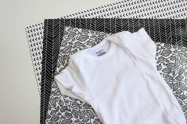 Cricut's new patterned vinyl iron on sheets are perfect for this DIY baby onesie project - there are SO many designs to choose from!