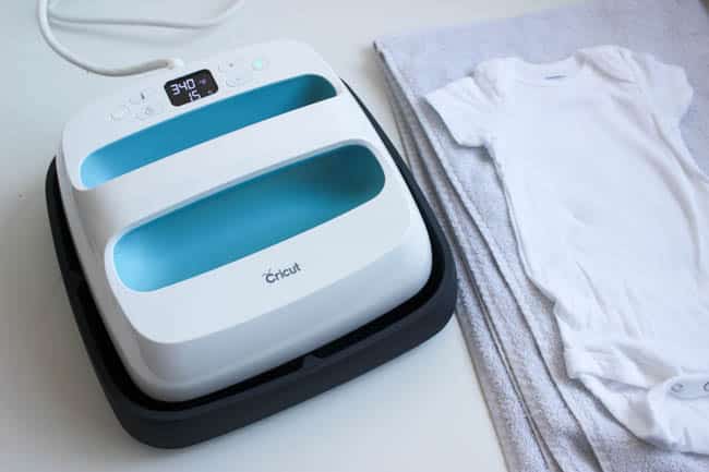 The Cruicut EasyPress made is super easy to press the iron on vinyl patterns onto the baby onesies