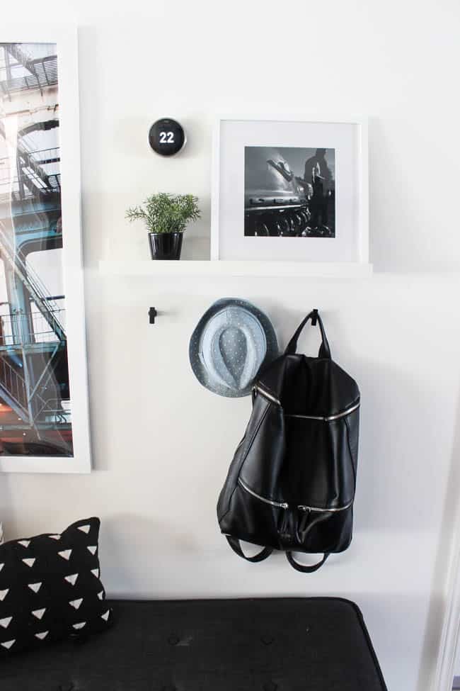 Beautiful hallway decor ideas! Love the eclectic mix of materials and styles in this space. Beautiful light flooring, gorgeous overlapping barn doors, modern artwork, and a vintage hallway runner complete the space. Perfect ideas to fill up a wide hallway!