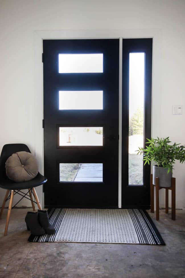 Thinking about replacing your front door? This is everything you need to know before you walk into The Home Depot and pick out a new design! We share how we got the proper measurements and picked our design elements before going to the store. Love the modern design of this new black front door!