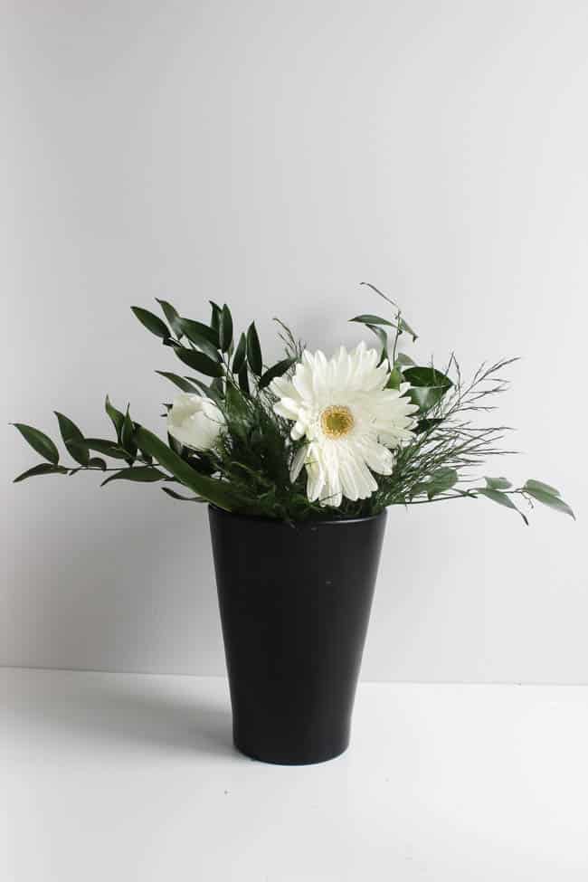 Black vase with white flowers