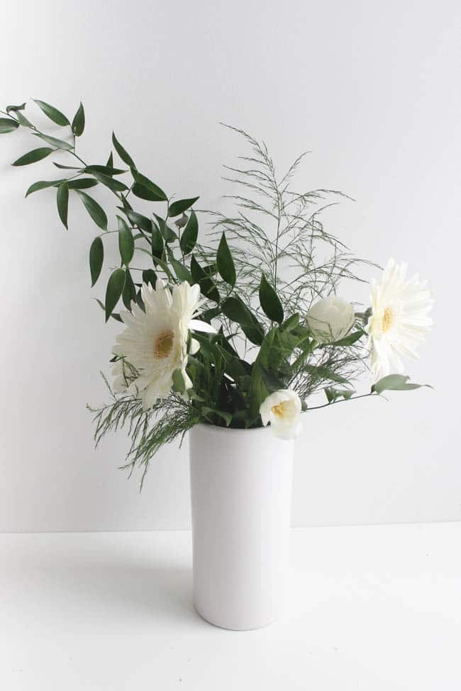 White vase with white flowers