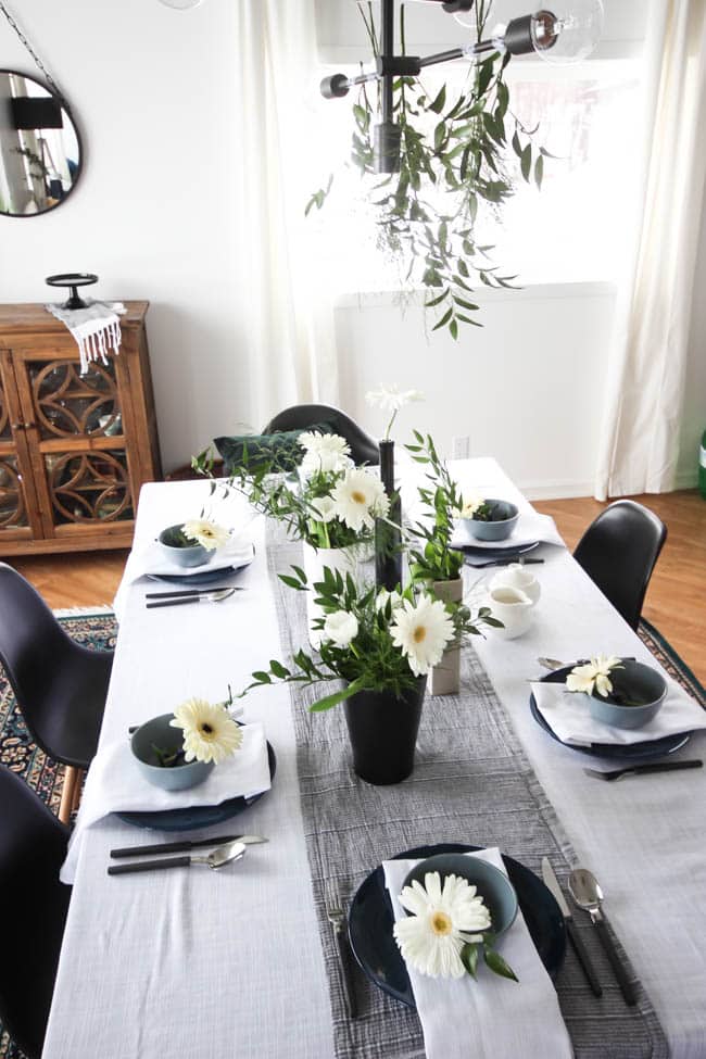 A pretty Mother's Day Tablescape. Love the earthy colours in this black, white, blue and green table setting! Beautiful floral centrepieces and modern place settings will make for the perfect spring event!