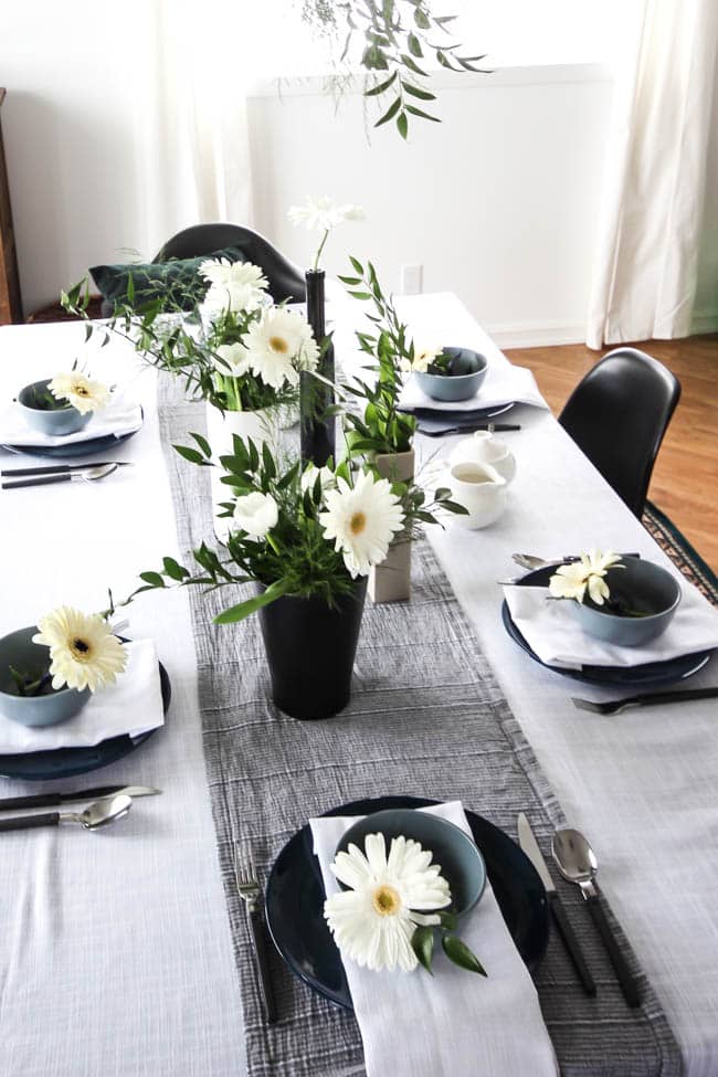 A pretty Mother's Day Tablescape. Love the earthy colours in this black, white, blue and green table setting! Beautiful floral centrepieces and modern place settings will make for the perfect spring event!