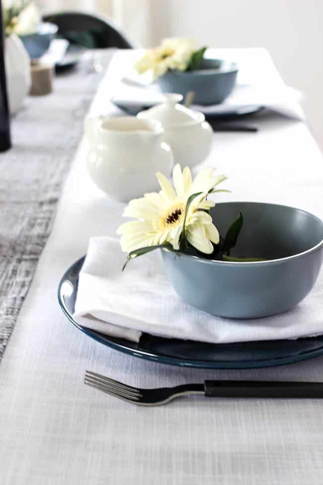 A pretty Mother's Day Tablescape. Love the earthy colours in this black, white, blue and green table setting! Beautiful floral centrepieces and modern place settings will make for the perfect spring event!